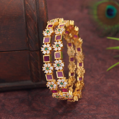 Orna Gold-Plated Floral Design Bangles with Ruby and Green Stone Embellishments - Set of 2